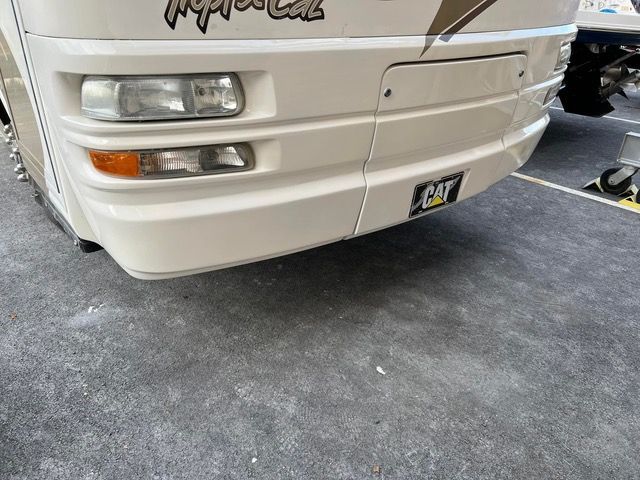 White rv bumper with a license plate.