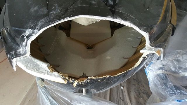 Black object with large oval opening, revealing light-colored interior.