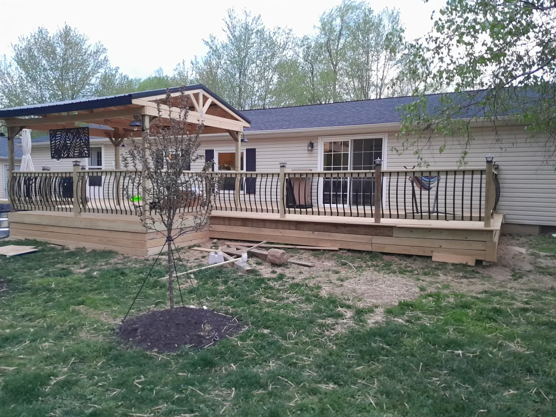 Custom wooden deck with pergola built for outdoor living and handyman deck services
