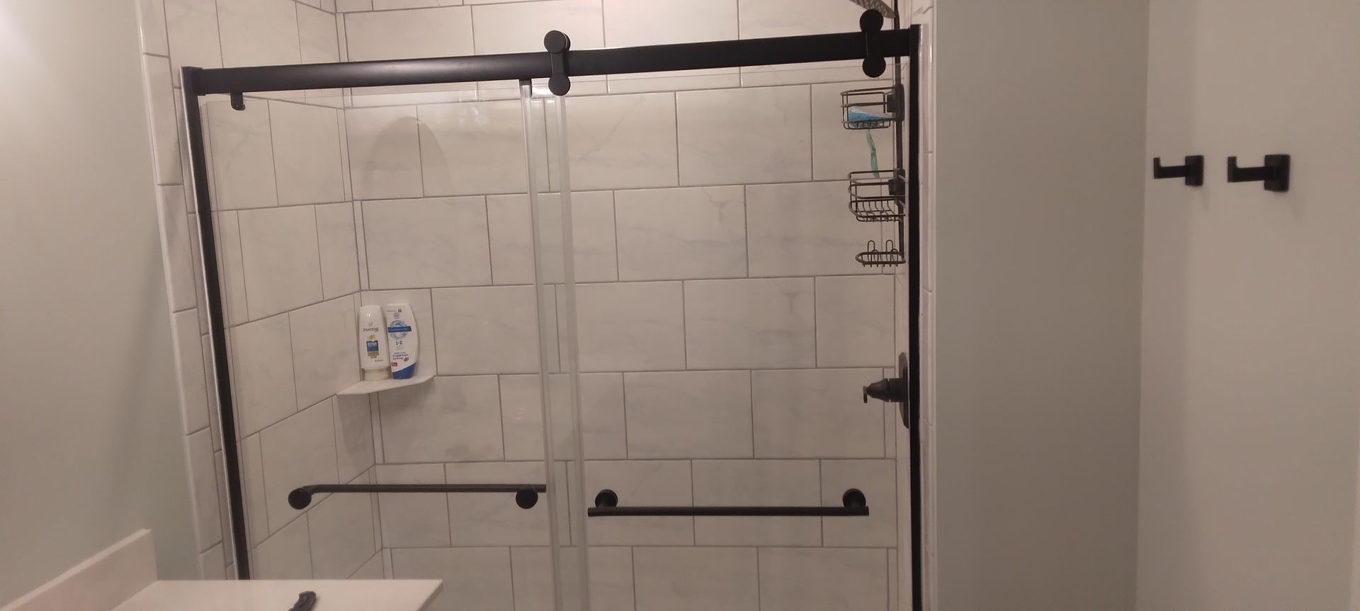Bathroom shower remodel with tiled walls and sliding glass doors installed professionally
