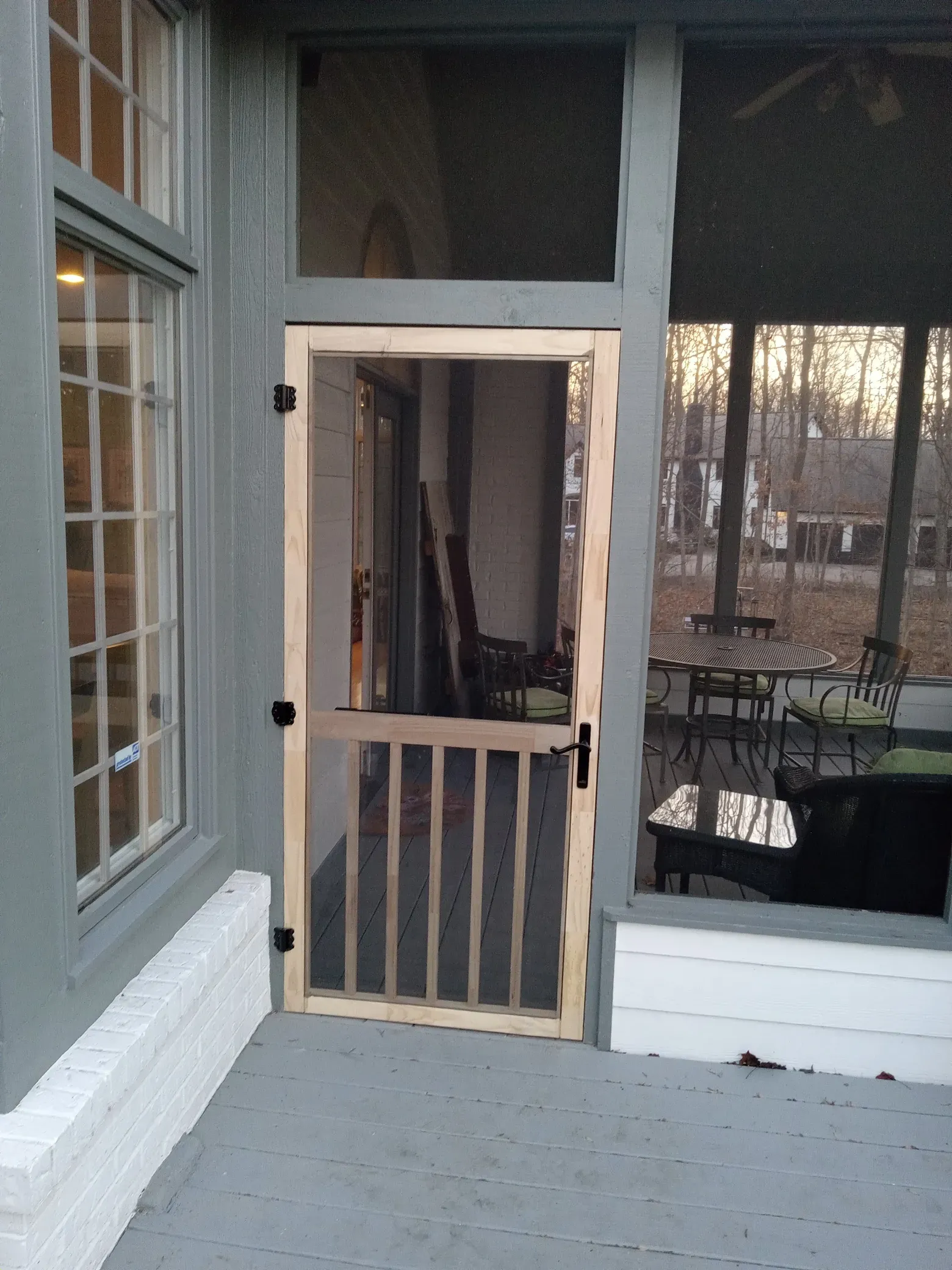 A screened in porch with a wooden door