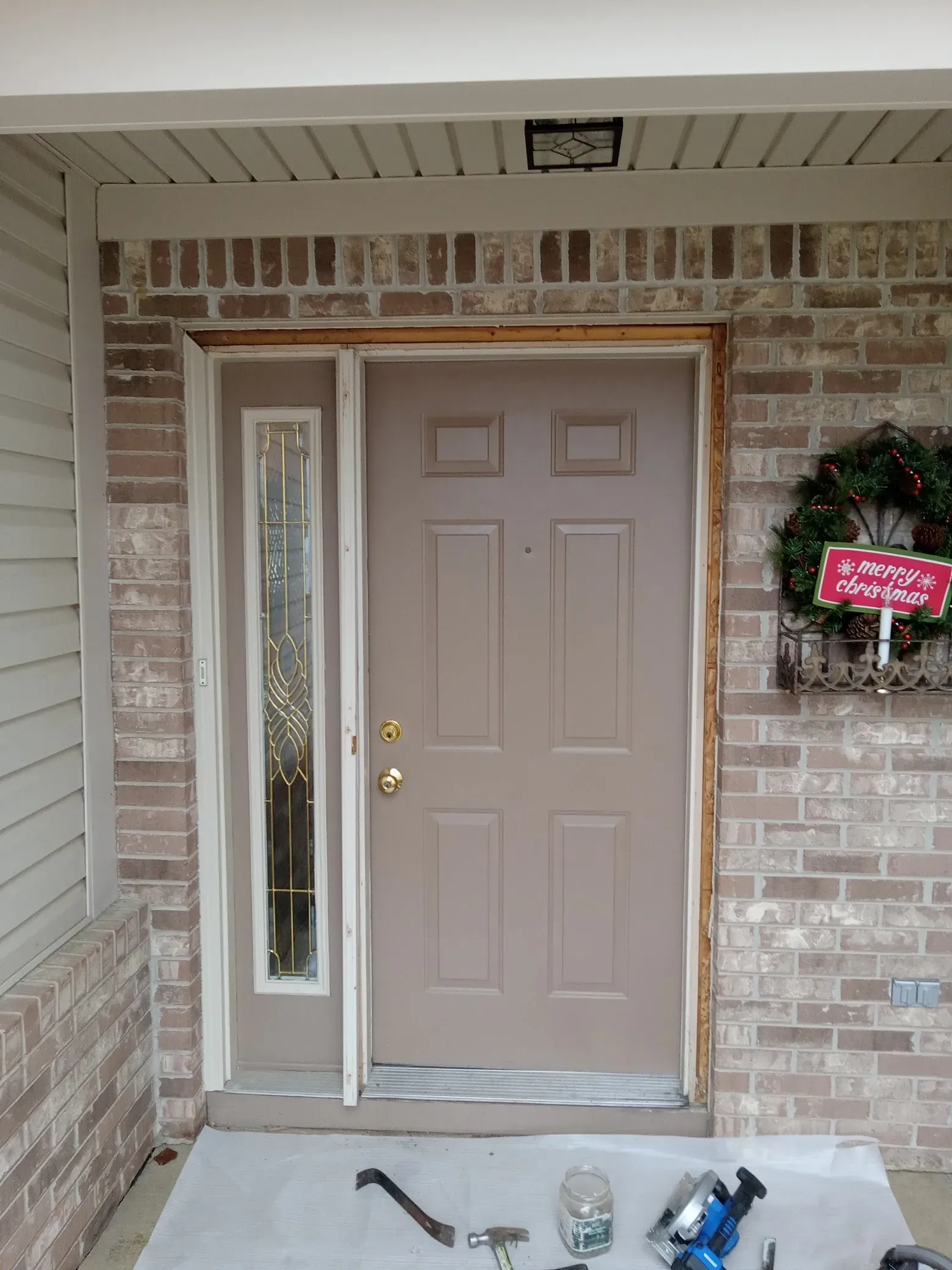 Front door repair with tools prepared for installation and handyman maintenance service