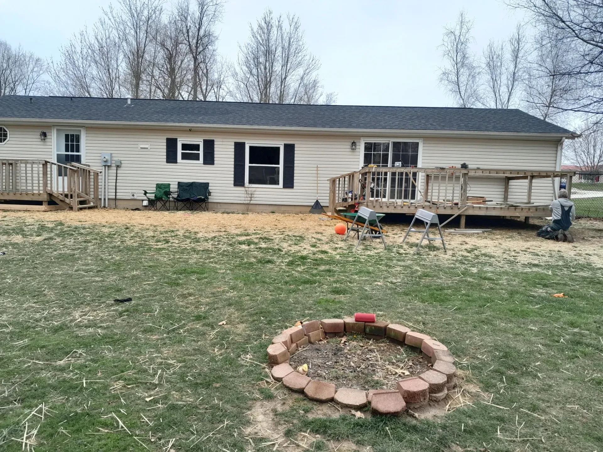 Before deck remodeling project showing worn wooden structure prior to handyman repair service