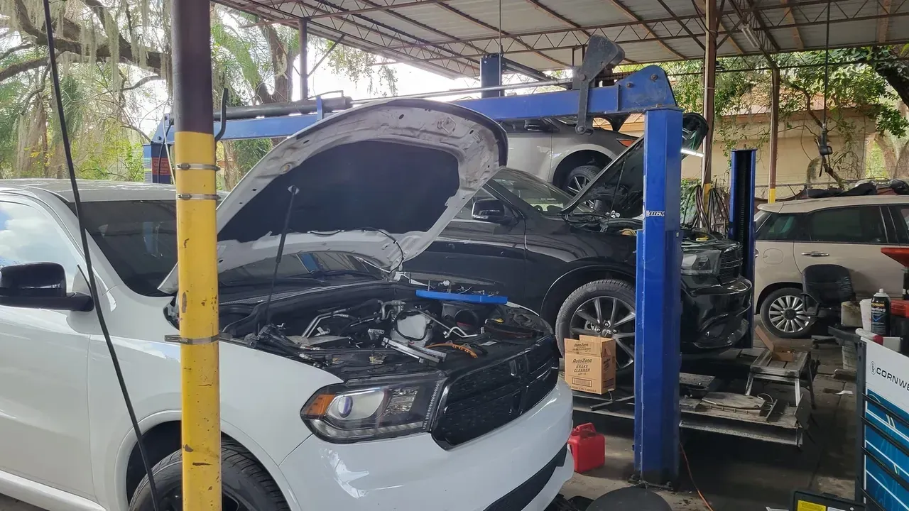 White automotive with an opened hood | Your Mechanic 813
