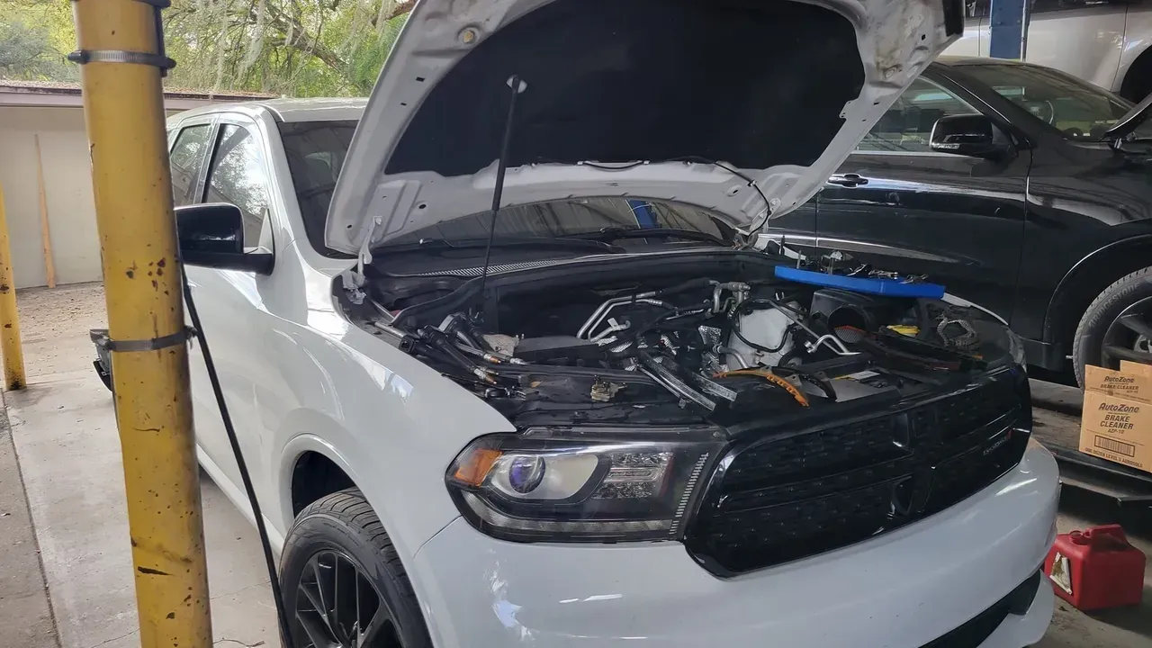 White vehicle with an opened hood | Your Mechanic 813