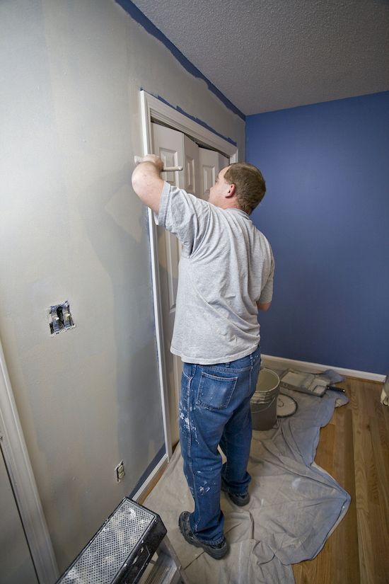 Professional painter painting a wall