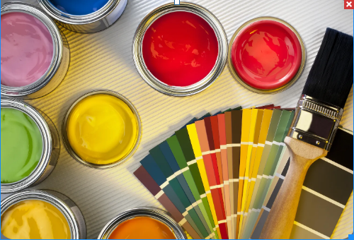 Open cans of different colored paint and paint color charts
