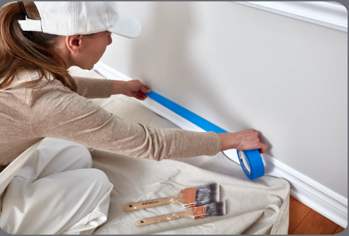 Interior Painter preparing a wall for paint