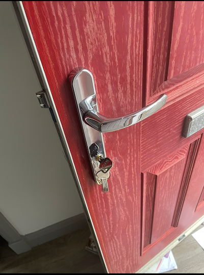 A close up of a red door with keys in it