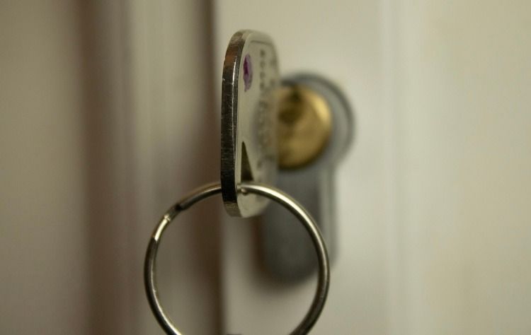 A close up of a key in a door lock