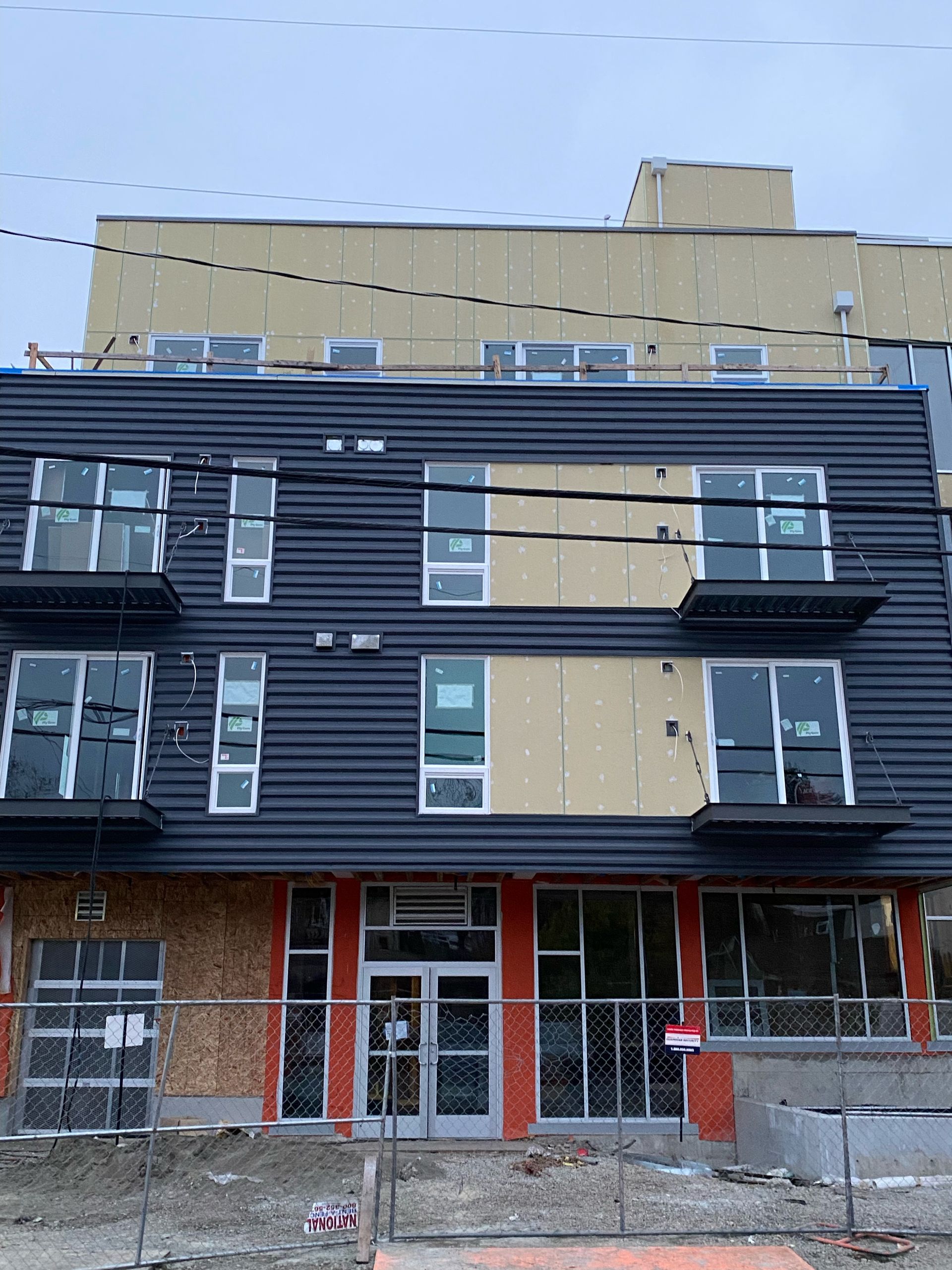 A building under construction with workers on top of it