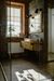 A bathroom with a sink , mirror and walk in shower.