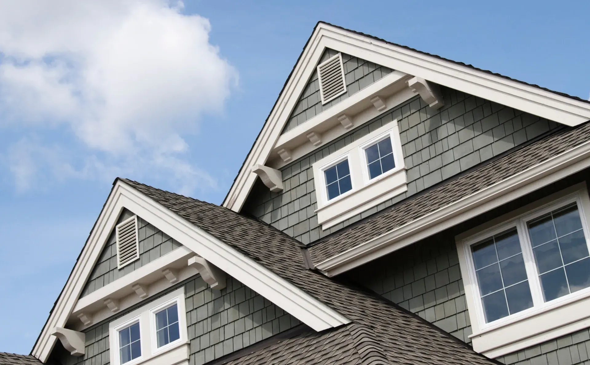 The roof of a house with a blue sky in the background.