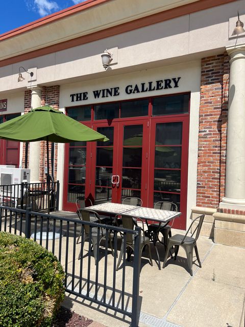 A restaurant called the wine gallery has tables and chairs outside