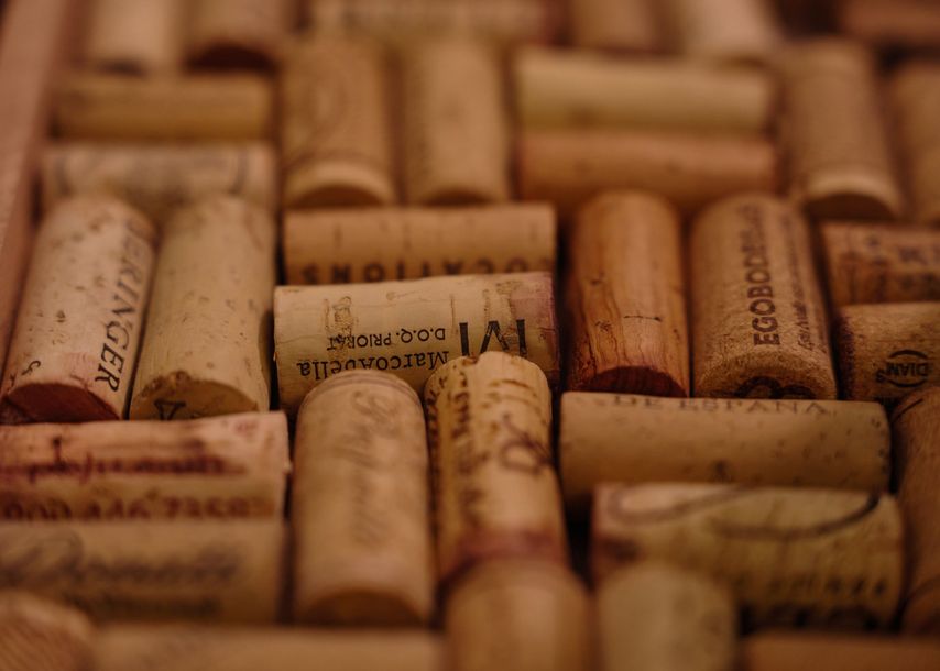 A bunch of wine corks are stacked on top of each other on a table.