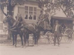 Photo of founder Thomas L. Harrison (seated right) with his horse drawn hearse
