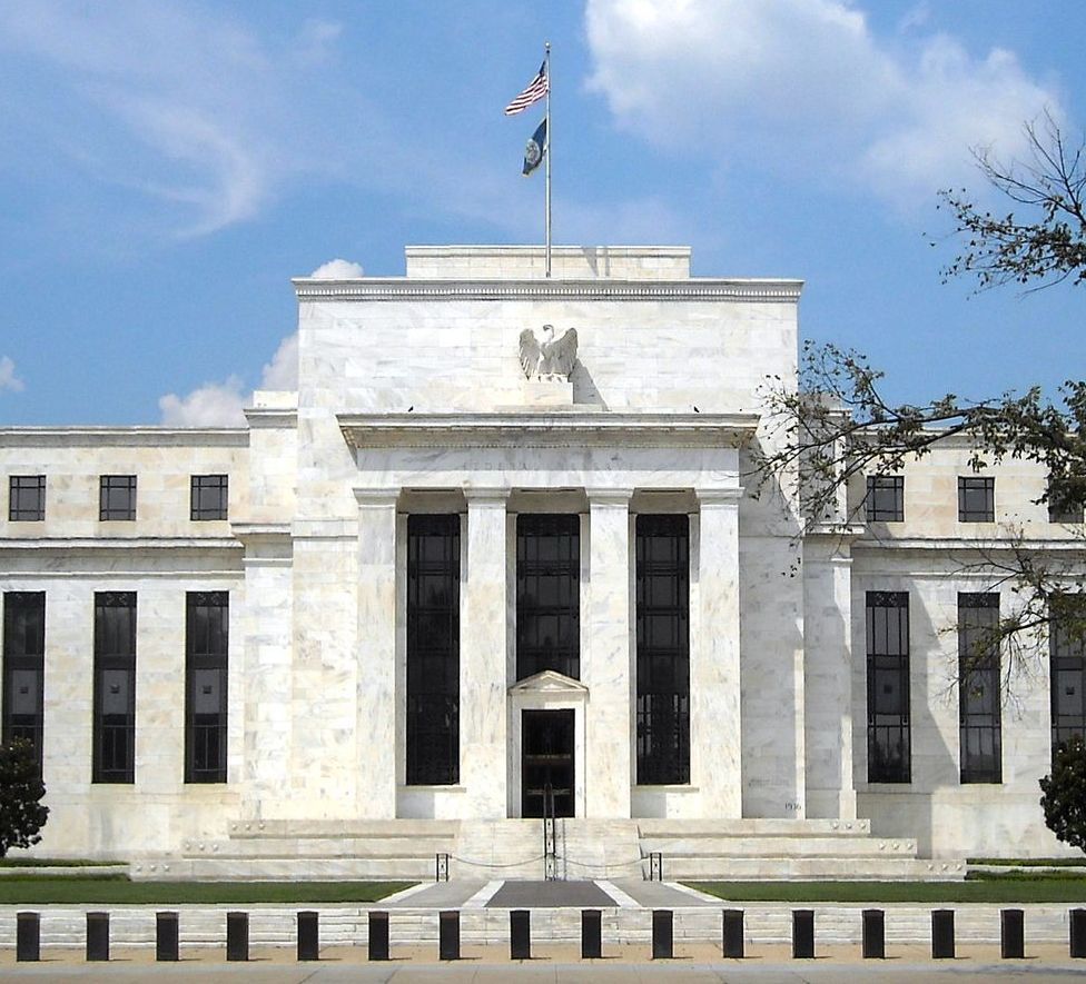 A large white building with a flag on top of it
