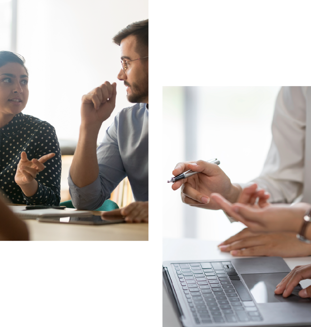 A man and a woman are sitting at a table with a laptop.