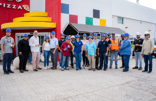 A group of people standing in front of a pizza restaurant