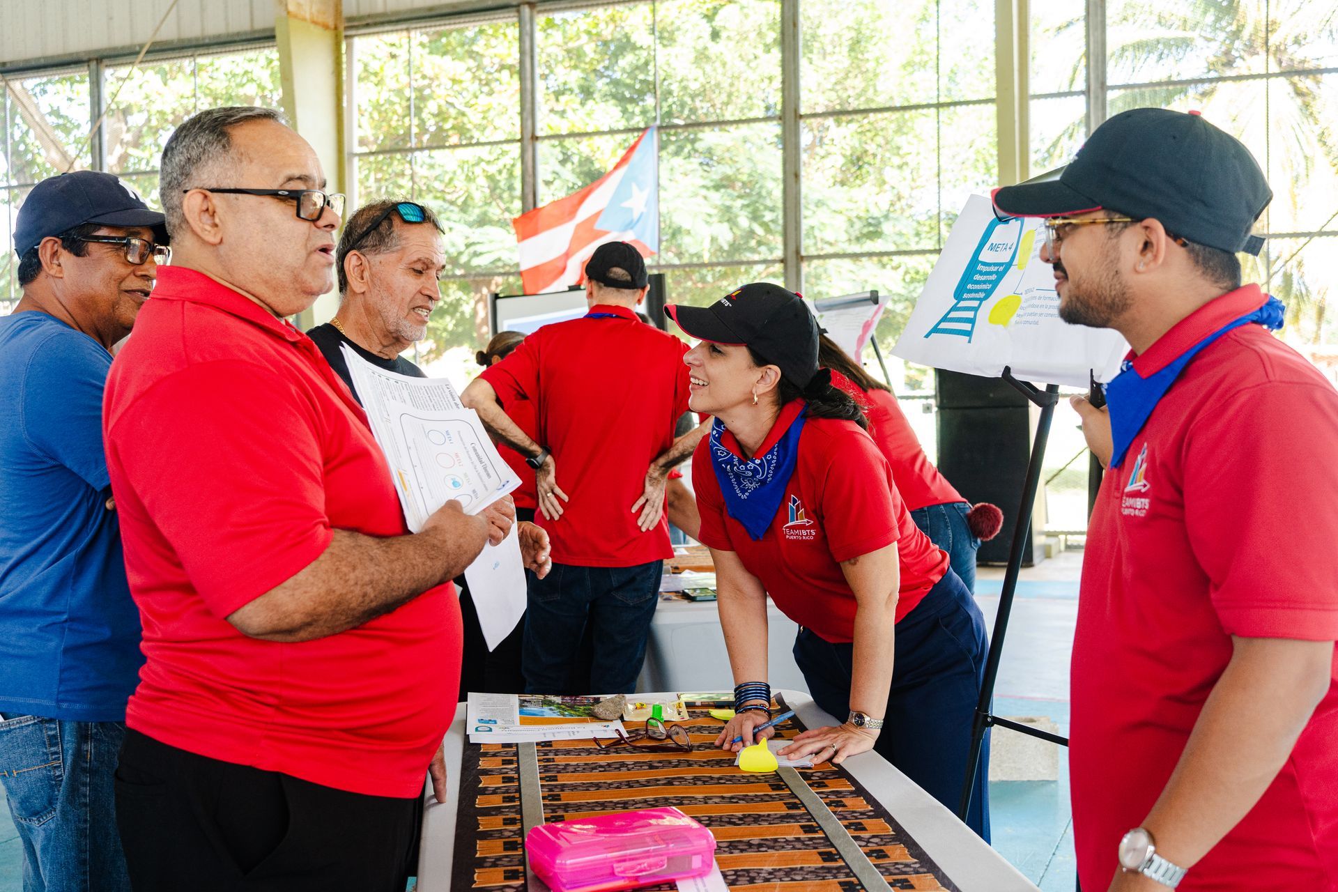 Tiburones community members asking IBTS staff questions at an info  