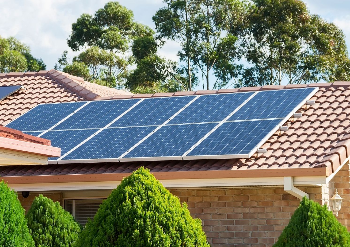 A brick house with solar panels on the roof