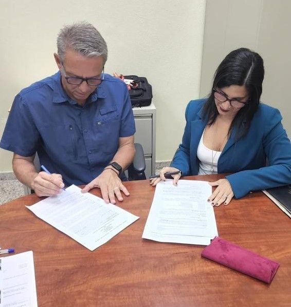 A man and a woman are sitting at a table looking at papers