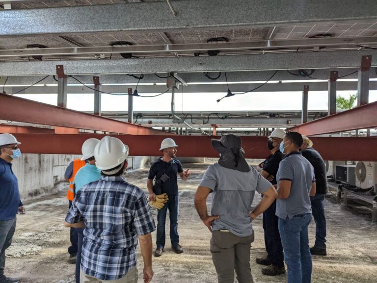 A group of construction workers wearing hard hats and masks