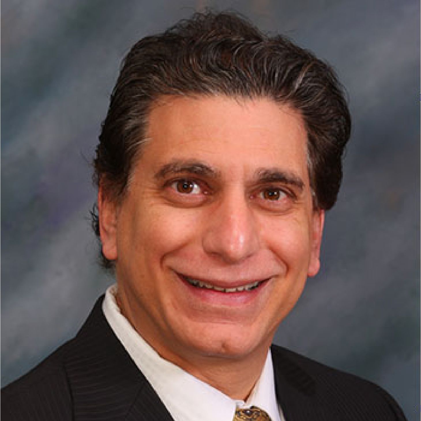 A man and a woman are sitting on a dock overlooking a lake.
