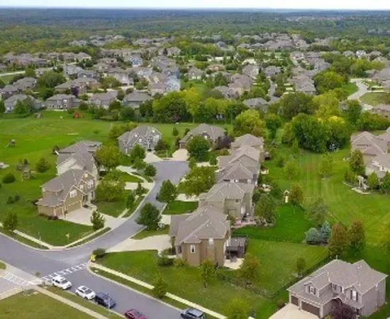 An aerial view of a residential neighborhood with lots of houses and trees.