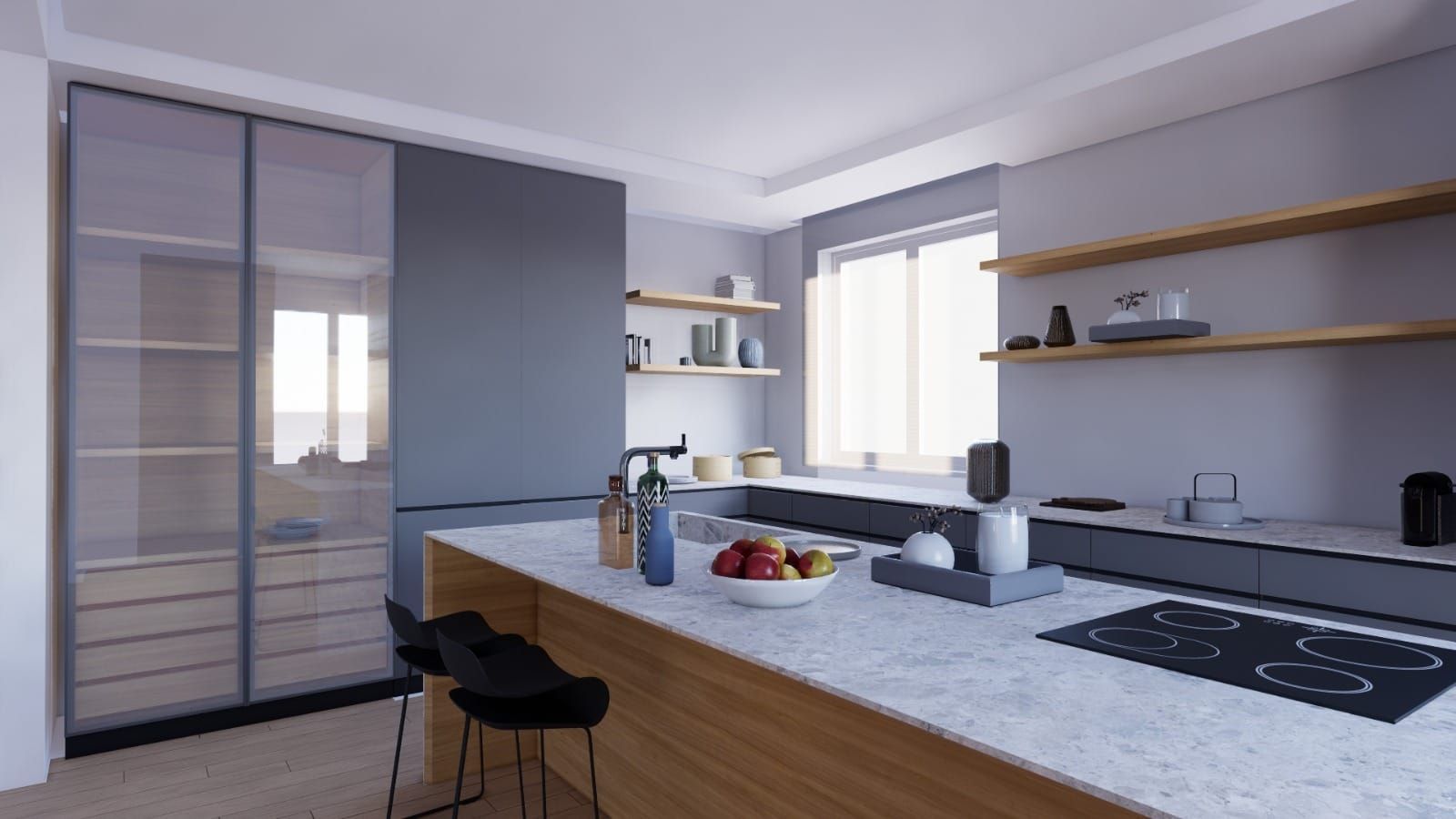 Una cucina con fornelli, forno, lavello e una ciotola di frutta sul bancone.