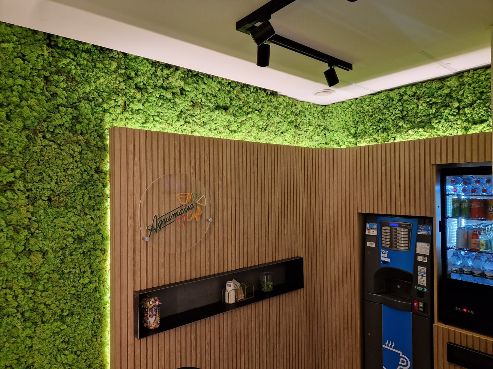 Una stanza con una parete verde e un distributore automatico.