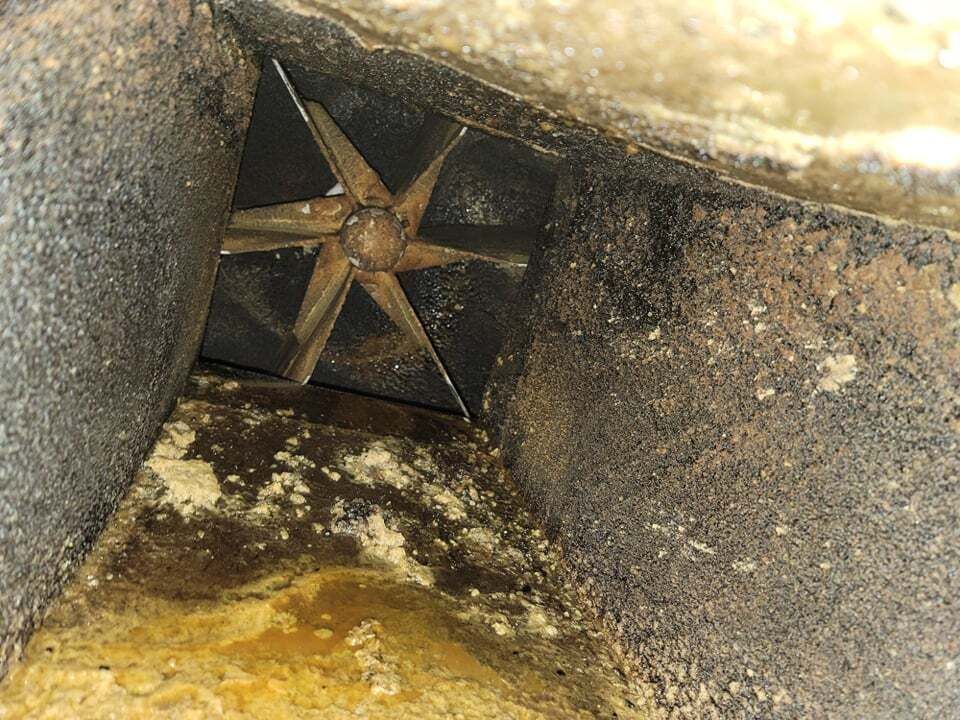 Inside a dirty air duct, a star-shaped damper is visible within a rectangular space.