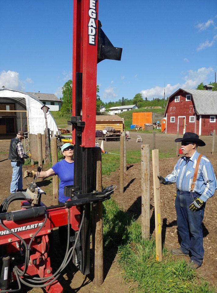 A man in a cowboy hat is standing next to a machine that says egade