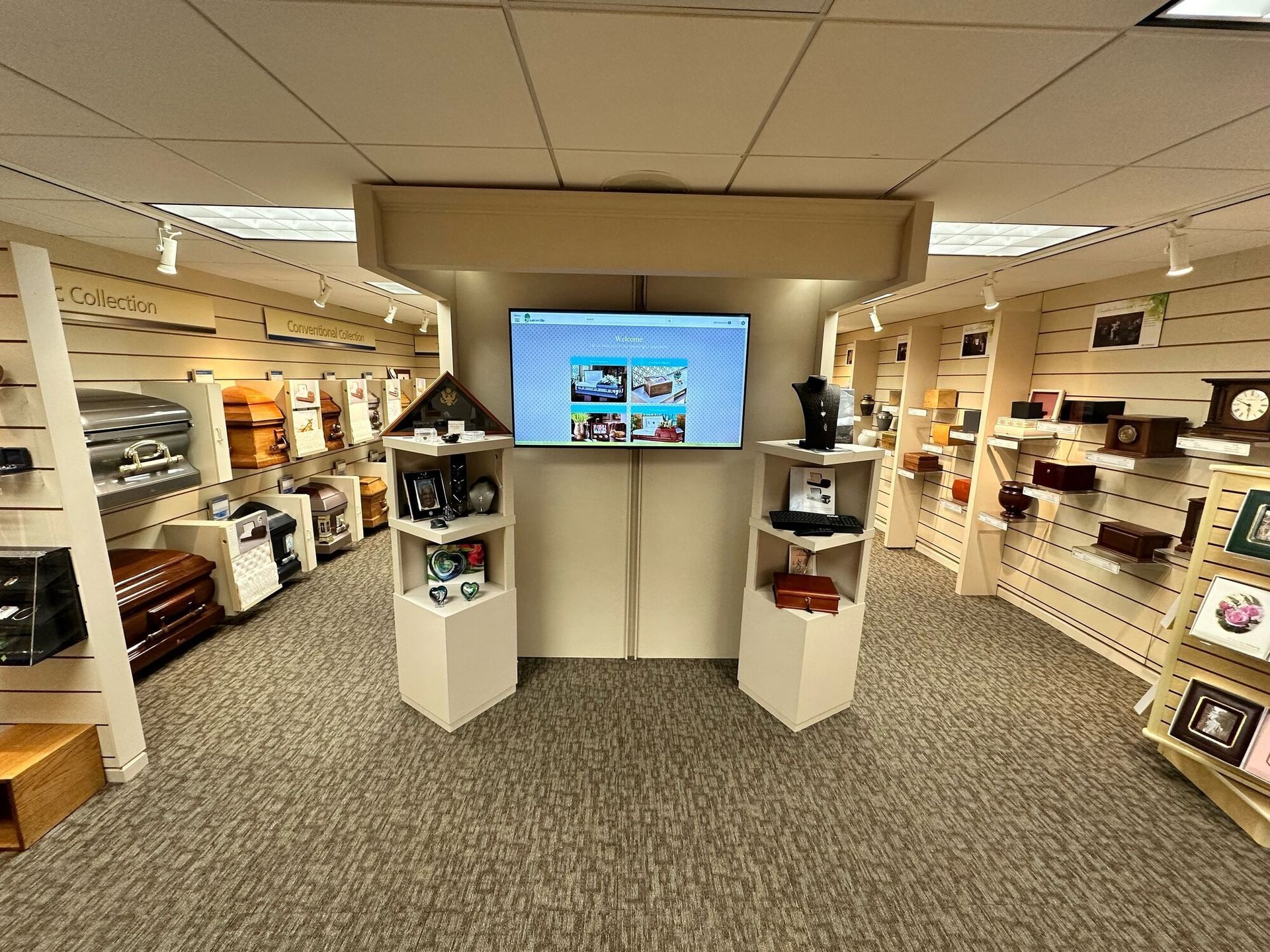 A store interior with shelves of items, a TV screen, and displays on pedestals.