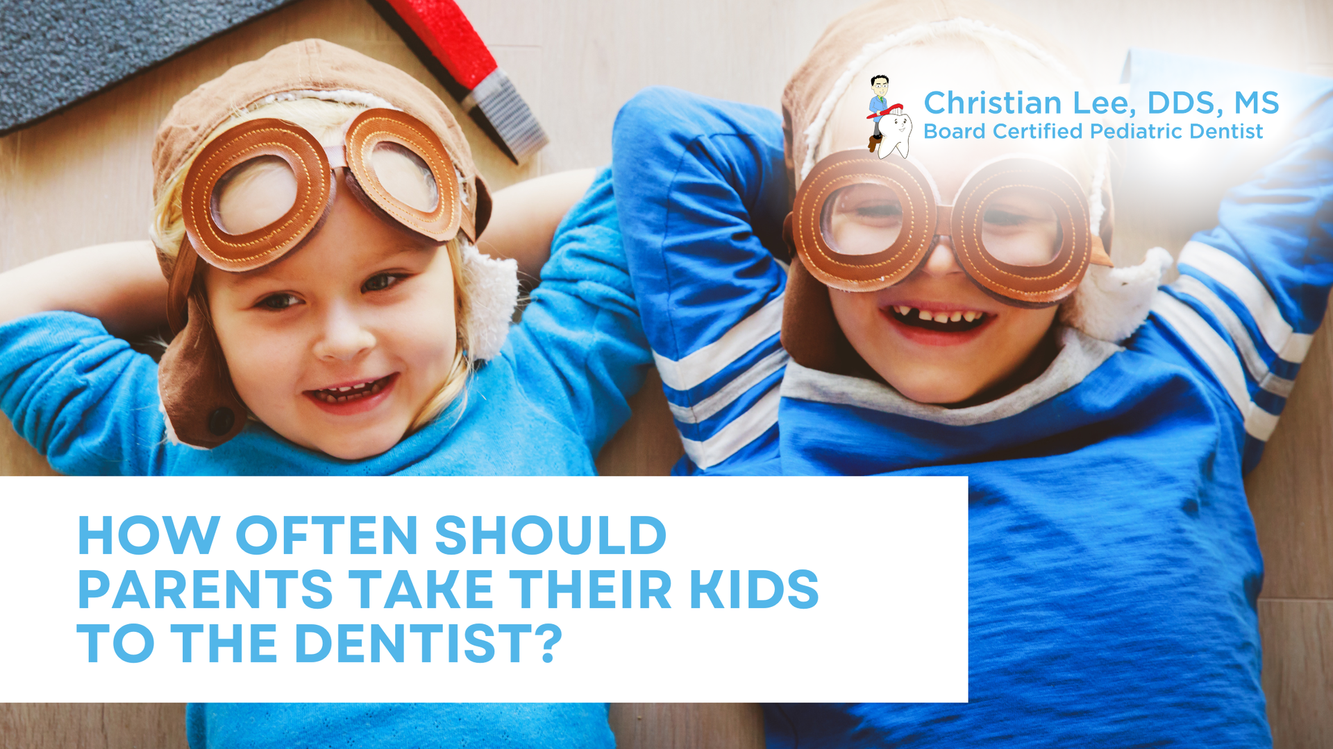 Two children smiling, wearing aviator goggles and blue shirts, with text 