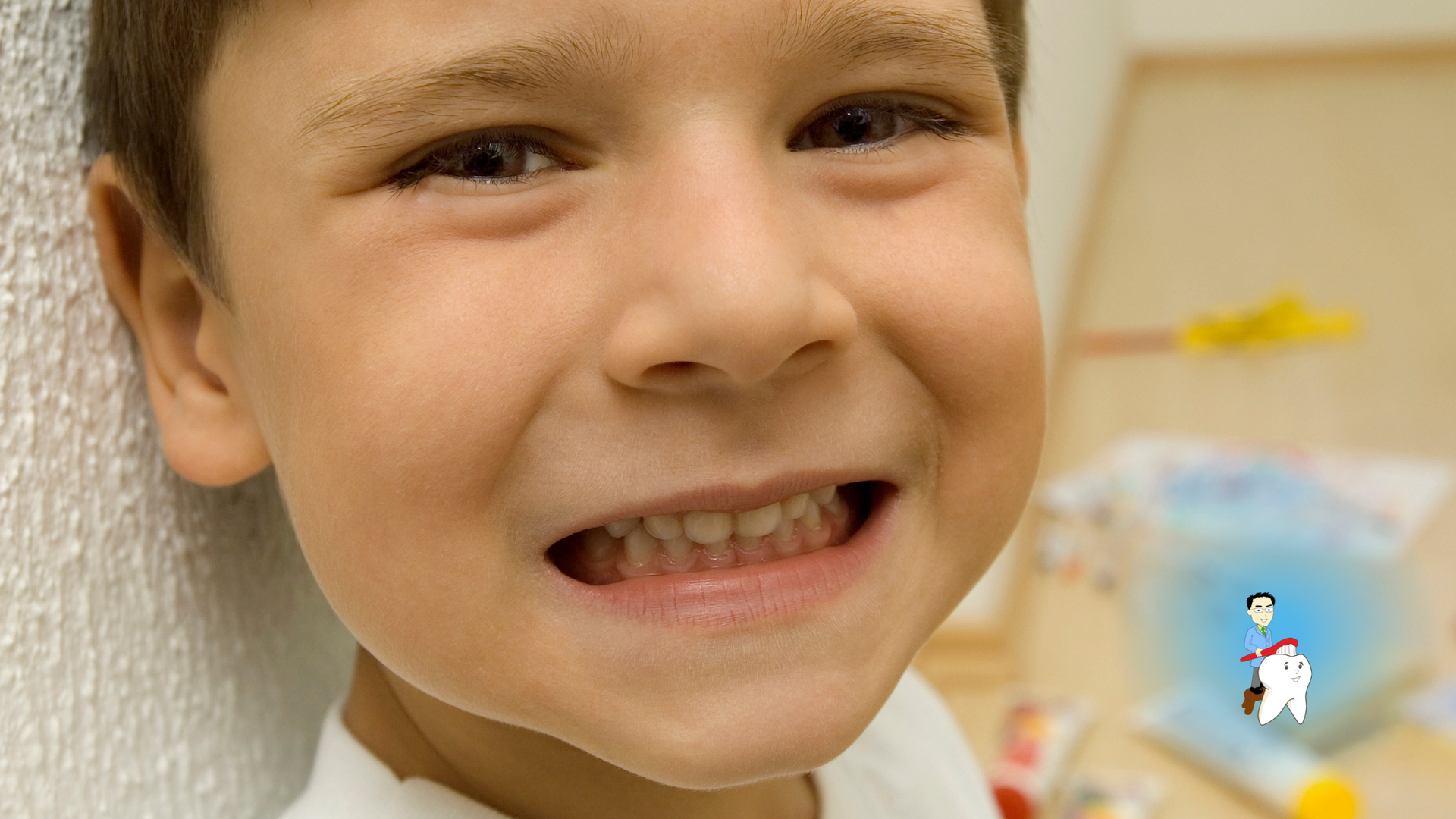 A young boy with braces on his teeth is smiling for the camera.