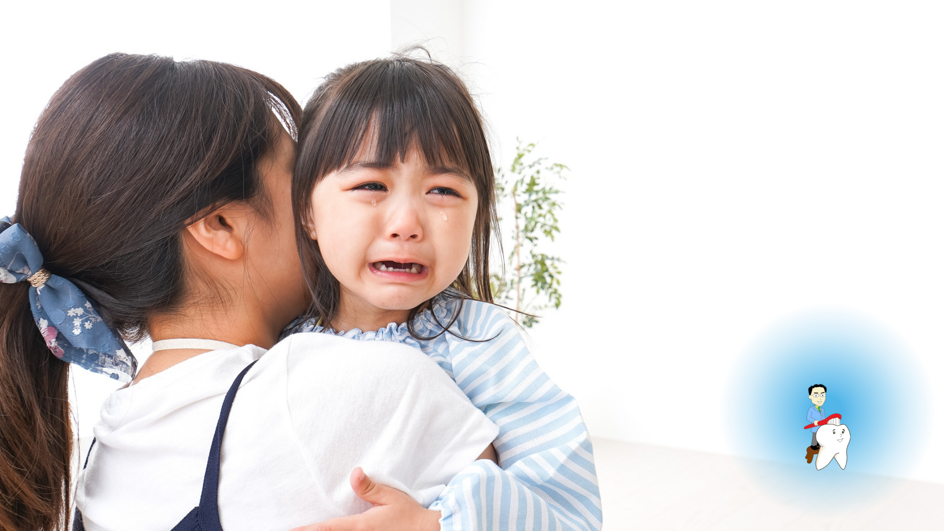 Woman holding a crying child; the child is looking toward the viewer.