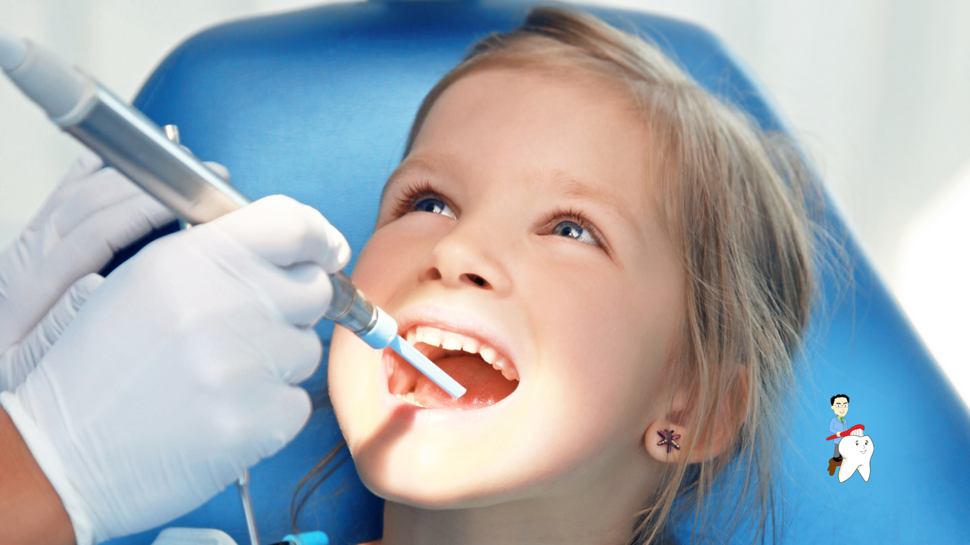 A little girl is getting her teeth examined by a dentist.