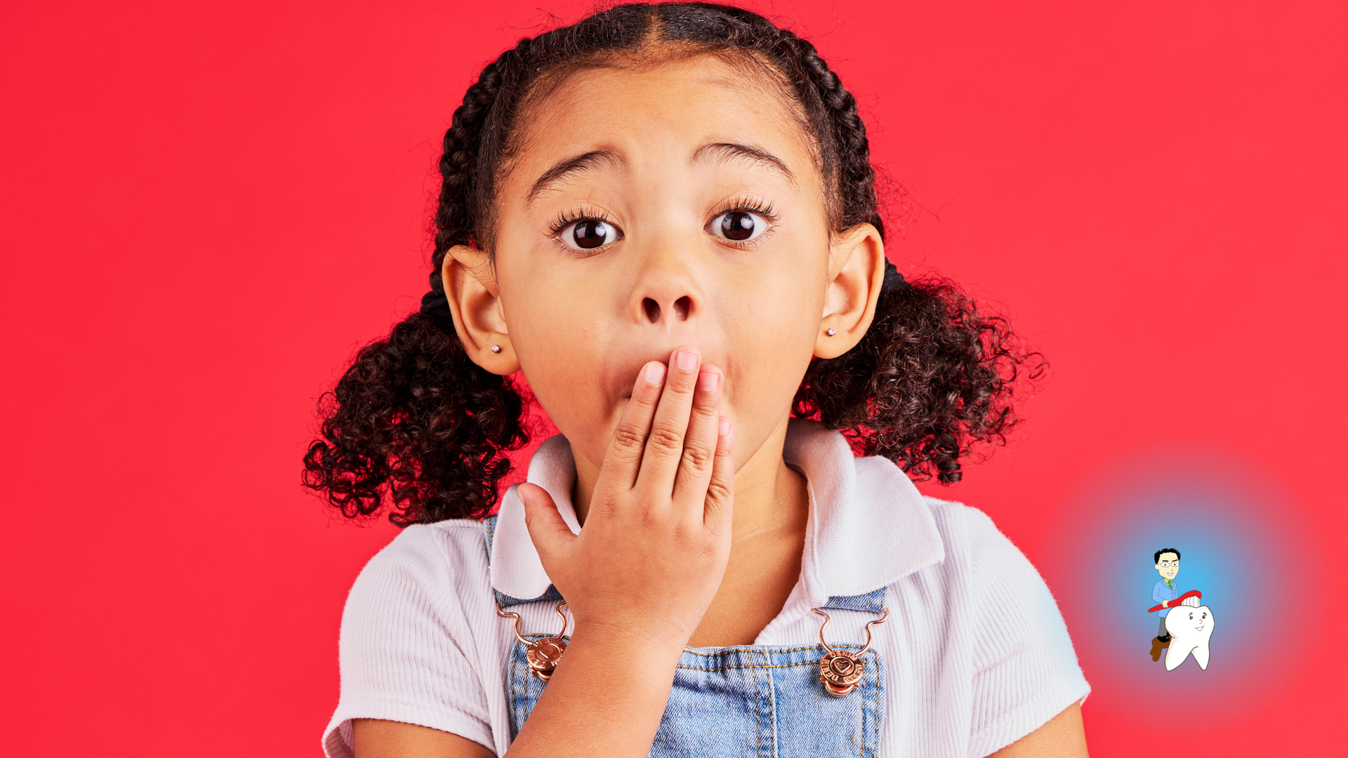 A little girl is covering her mouth with her hand.
