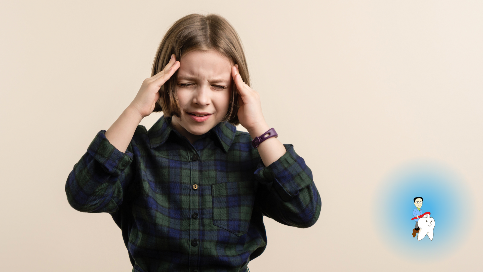 A young girl is holding her head because she has a headache.