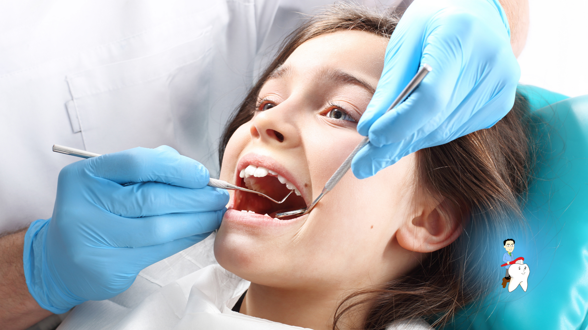 A young girl is getting her teeth examined by a dentist.