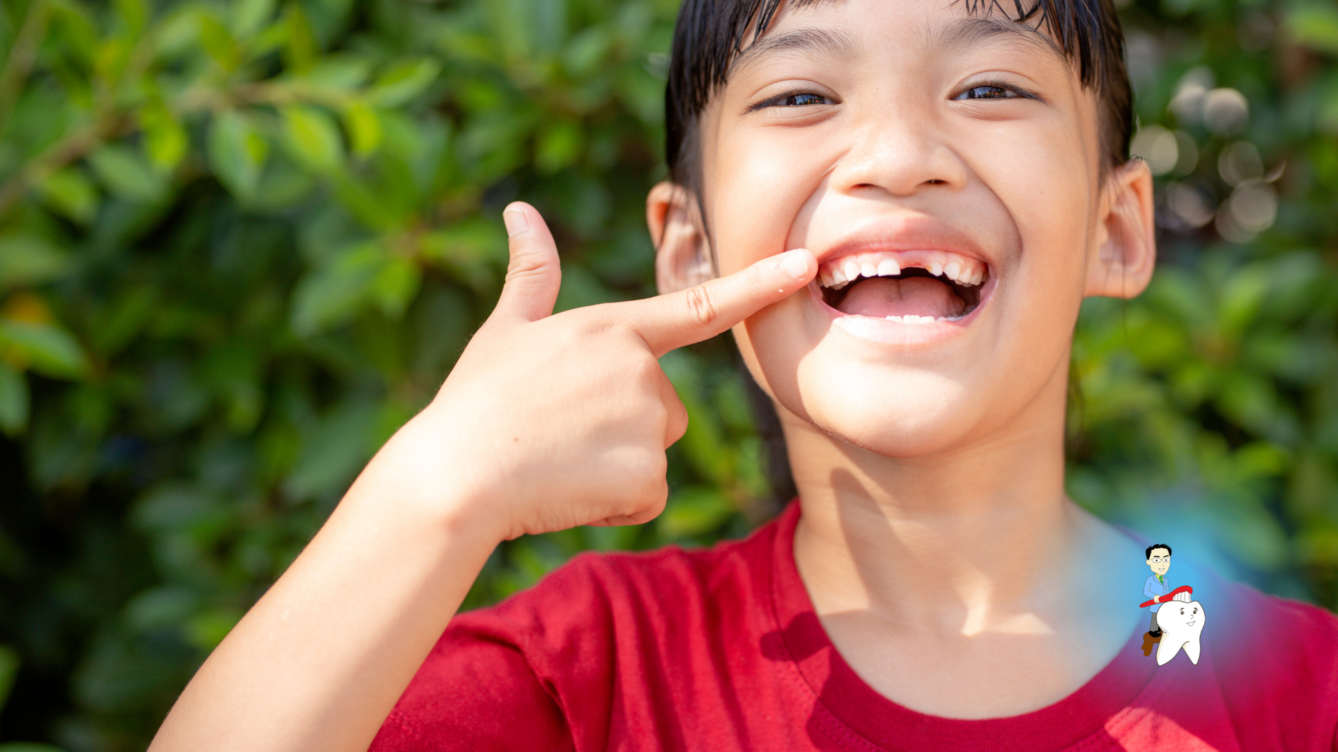 A young boy is pointing at his missing tooth.
