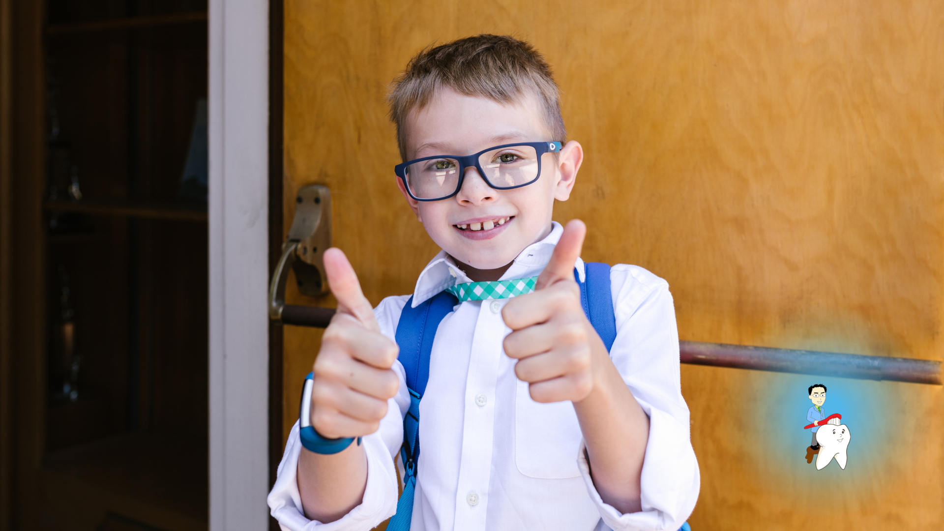 Boy in glasses with thumbs up, blue backpack, white shirt, and bow tie in front of a wooden door.