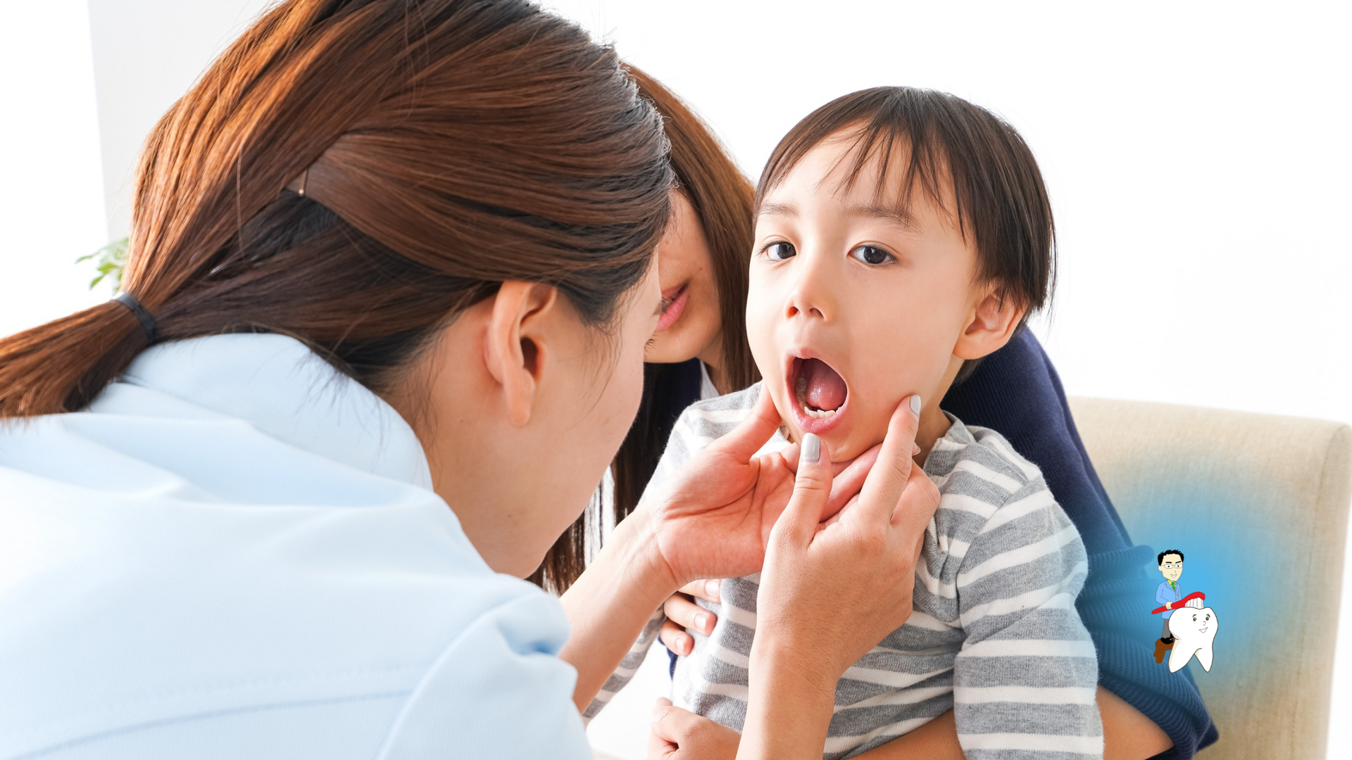 Dentist examining a young child's mouth; a parent is present. Bright, indoors.