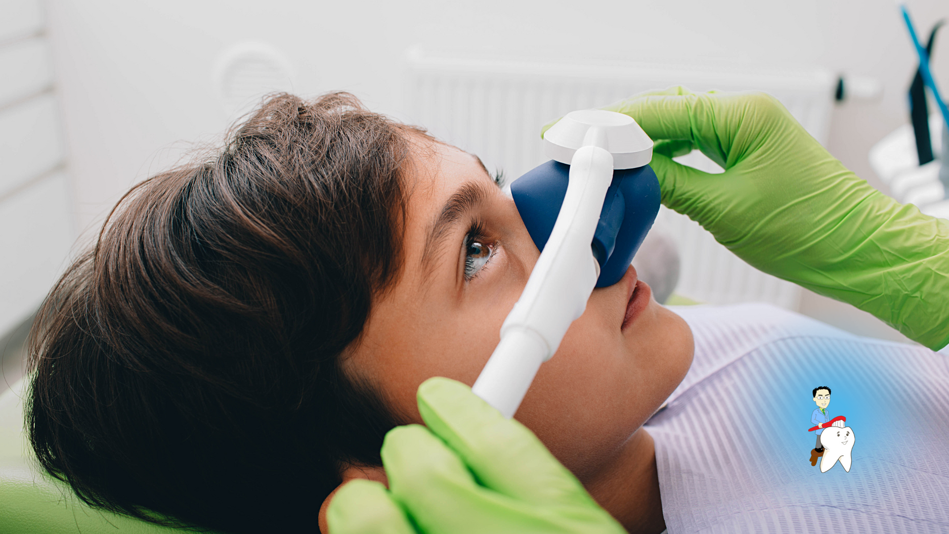 A young boy is laying in a dental chair with an oxygen mask on his nose.
