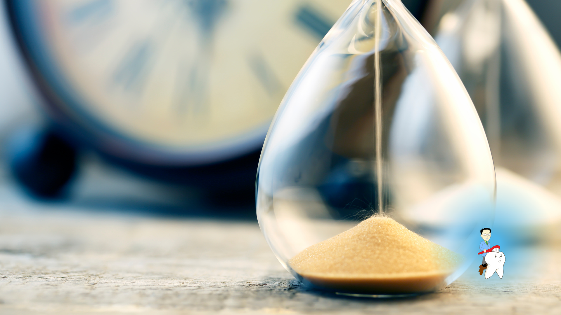 Hourglass with sand at bottom, background includes a clock.