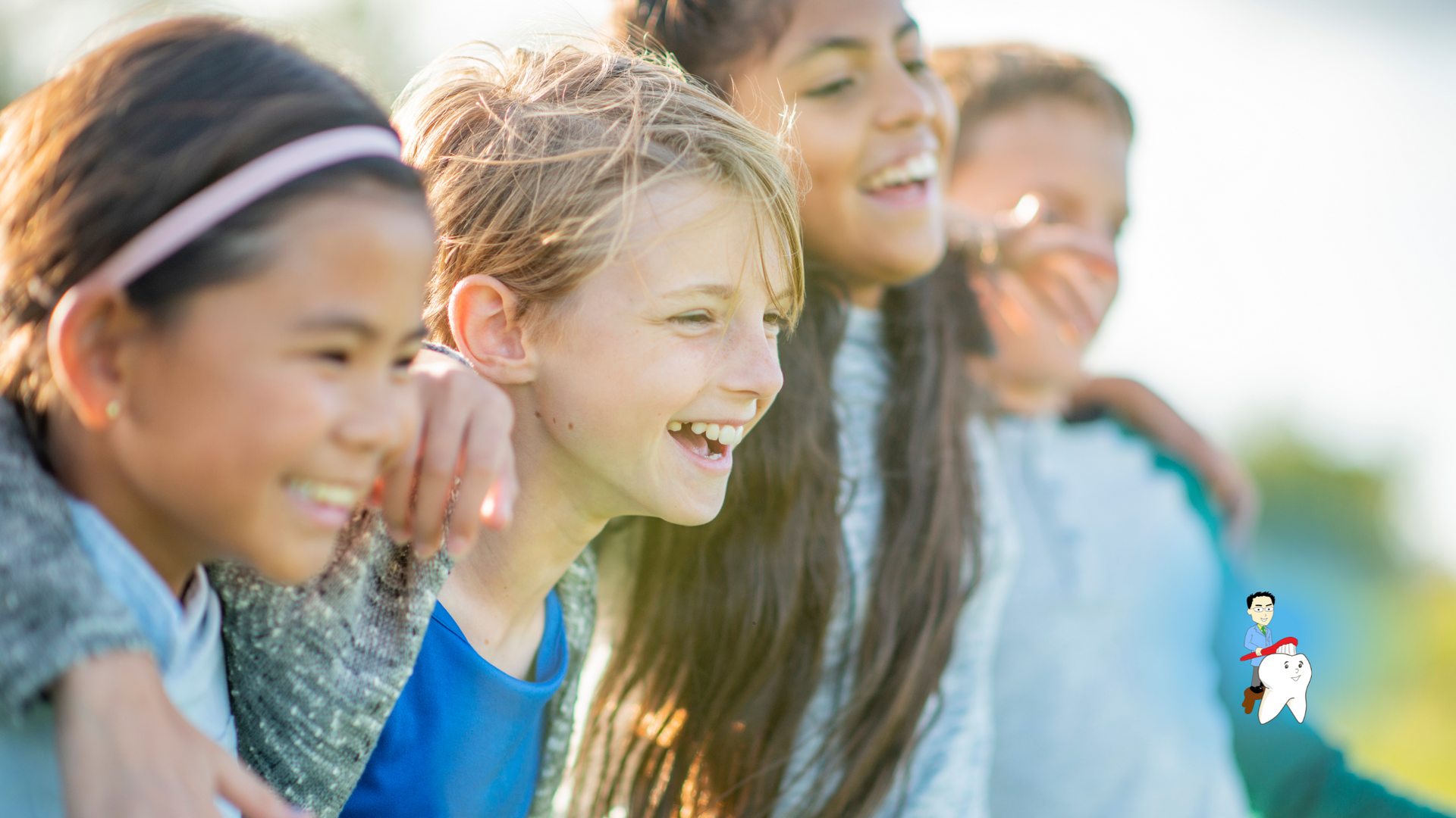A group of children are standing next to each other and smiling.