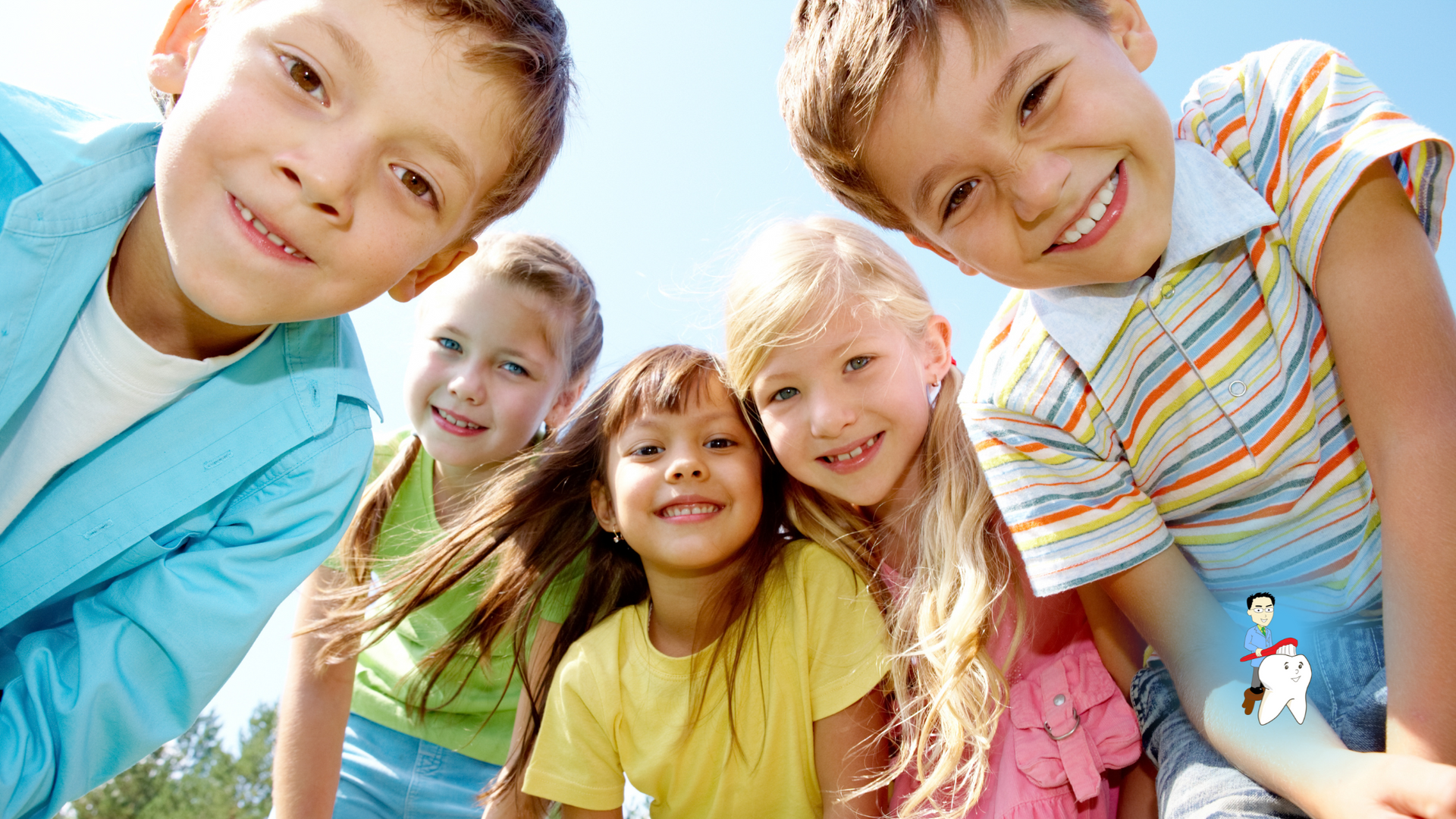 A group of children are posing for a picture and smiling for the camera.