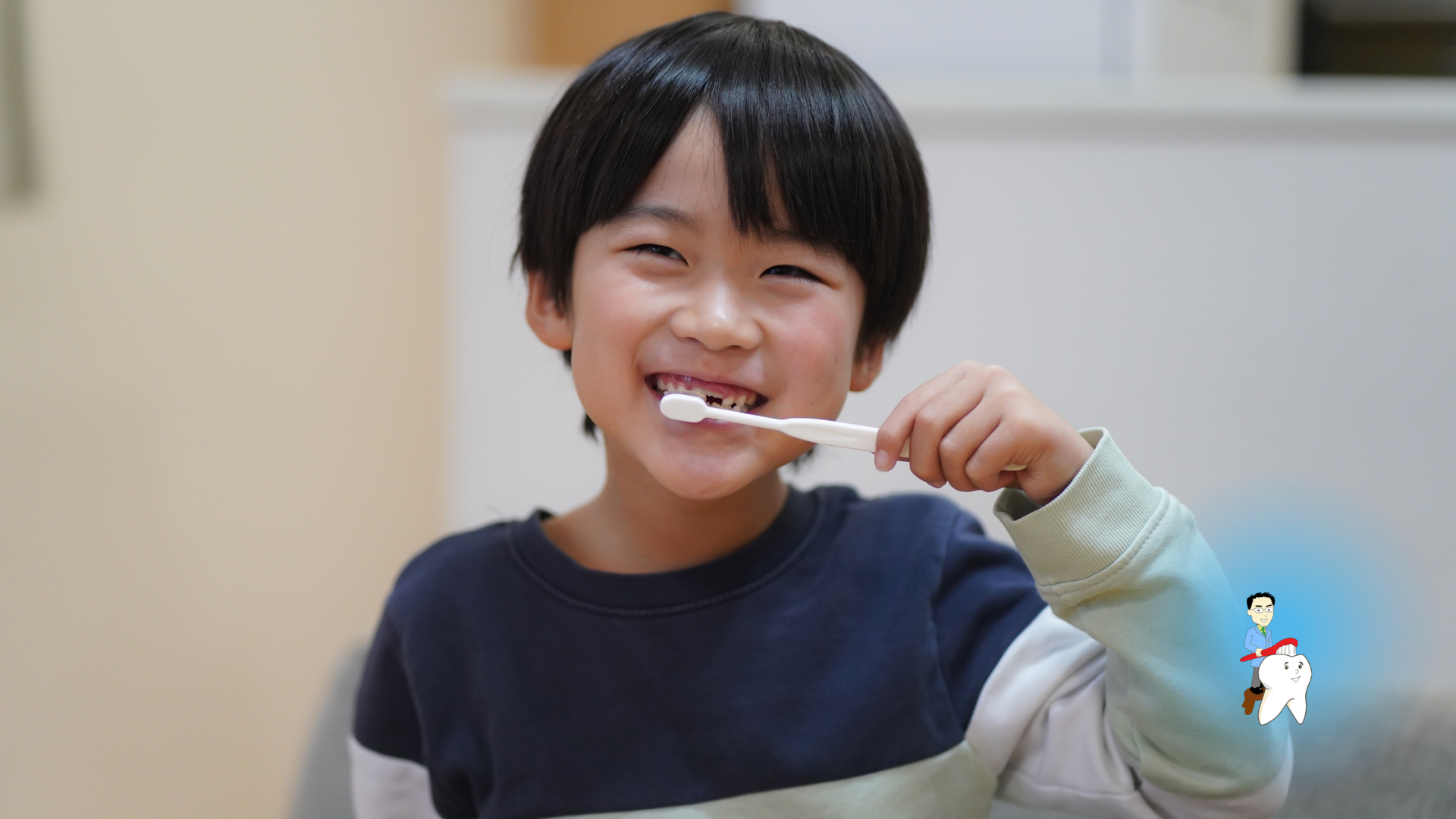 Boy smiling, brushing teeth. Indoors, blurred background.