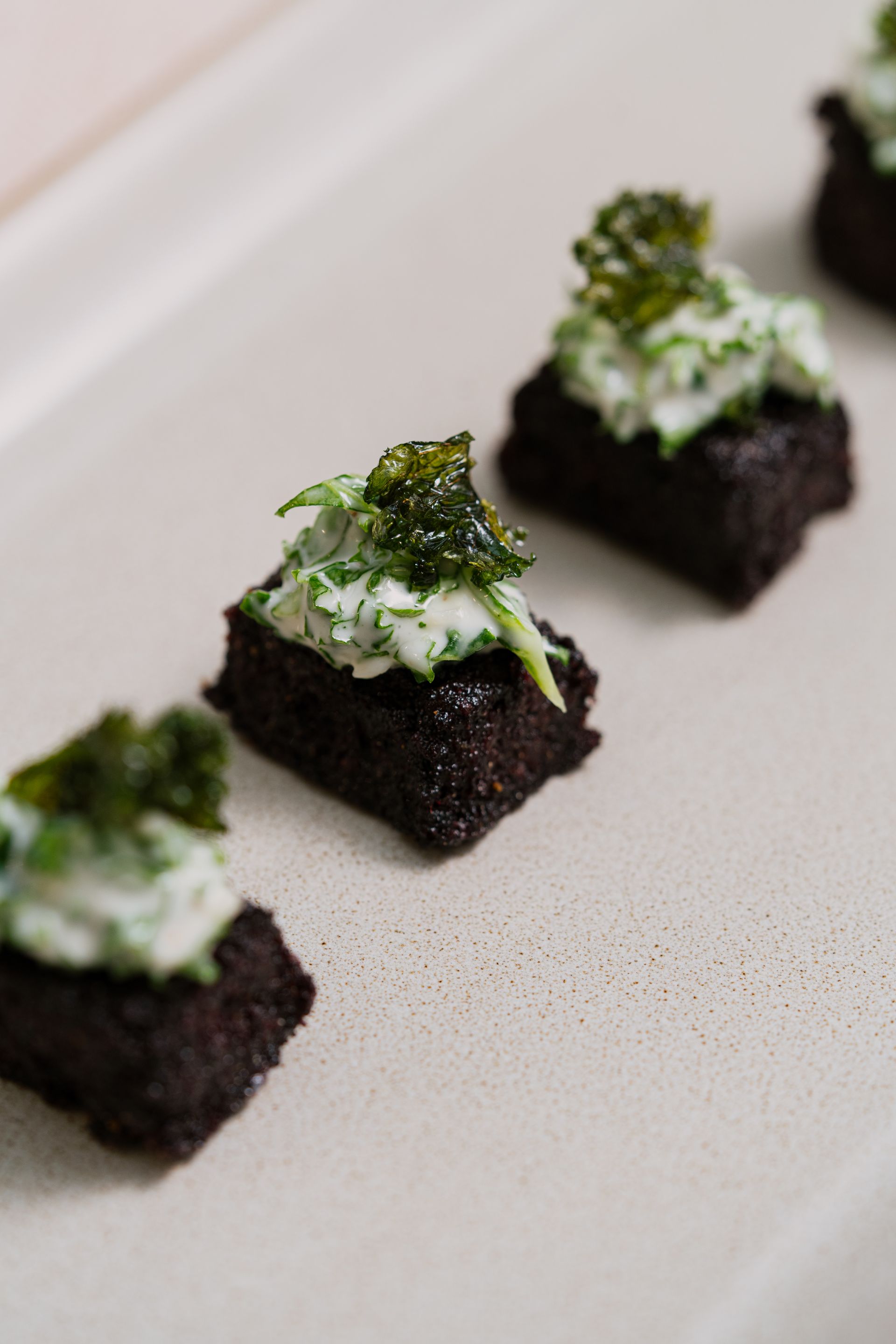 Black polenta base with kale, parmesan & truffle Caesar salad 